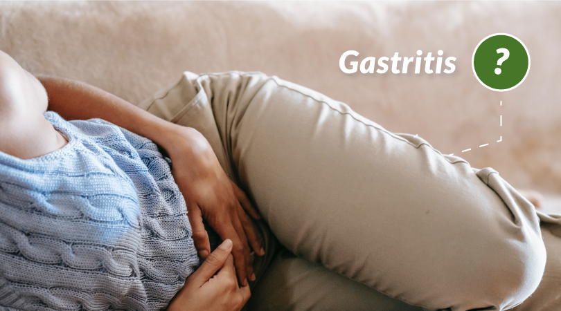 Woman lying down holding her stomach because of gastritis pain