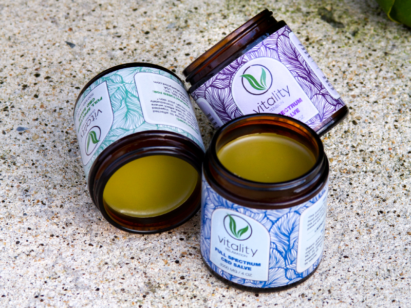 Three open containers of Vitality's CBD salves for chronic pain, relaxation, and tension.