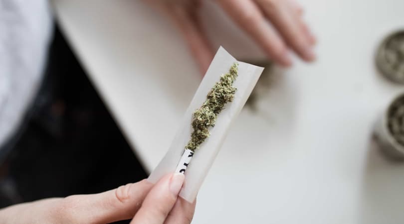 Smoking paper filled with Delta-8 flower about to be rolled.