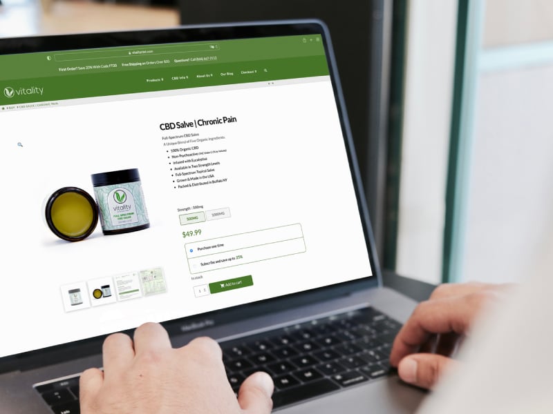 Person buying organic CBD salve on a laptop on Vitality CBD's website.