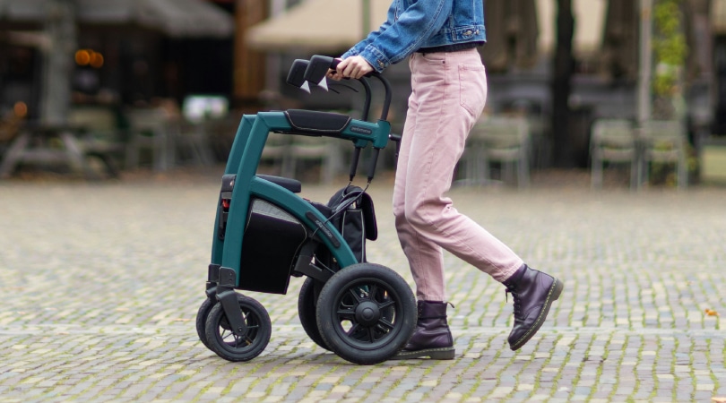 Person walking with a rollator.