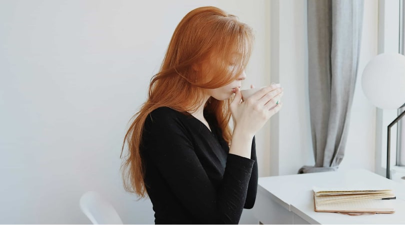 Woman drinking a cup of coffee.