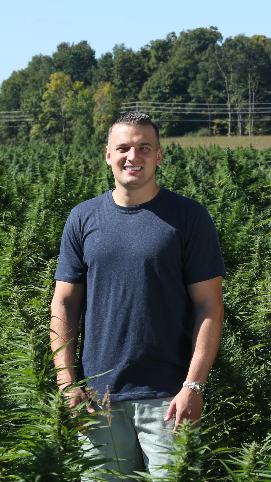 Scott Mazza standing in a hemp field.